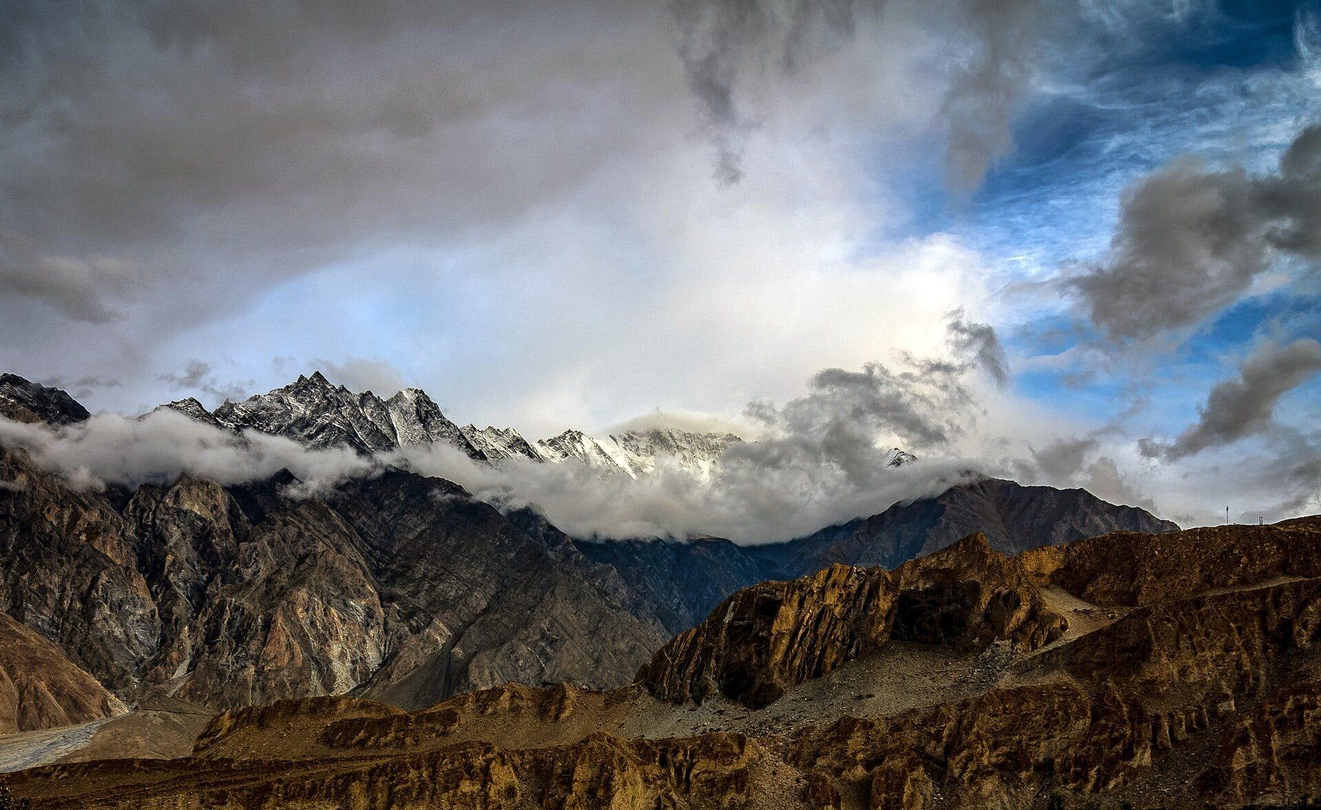 The jagged Passu Cones above the Hunza valley in the Karakoram, Pakistan, under heavy cloud